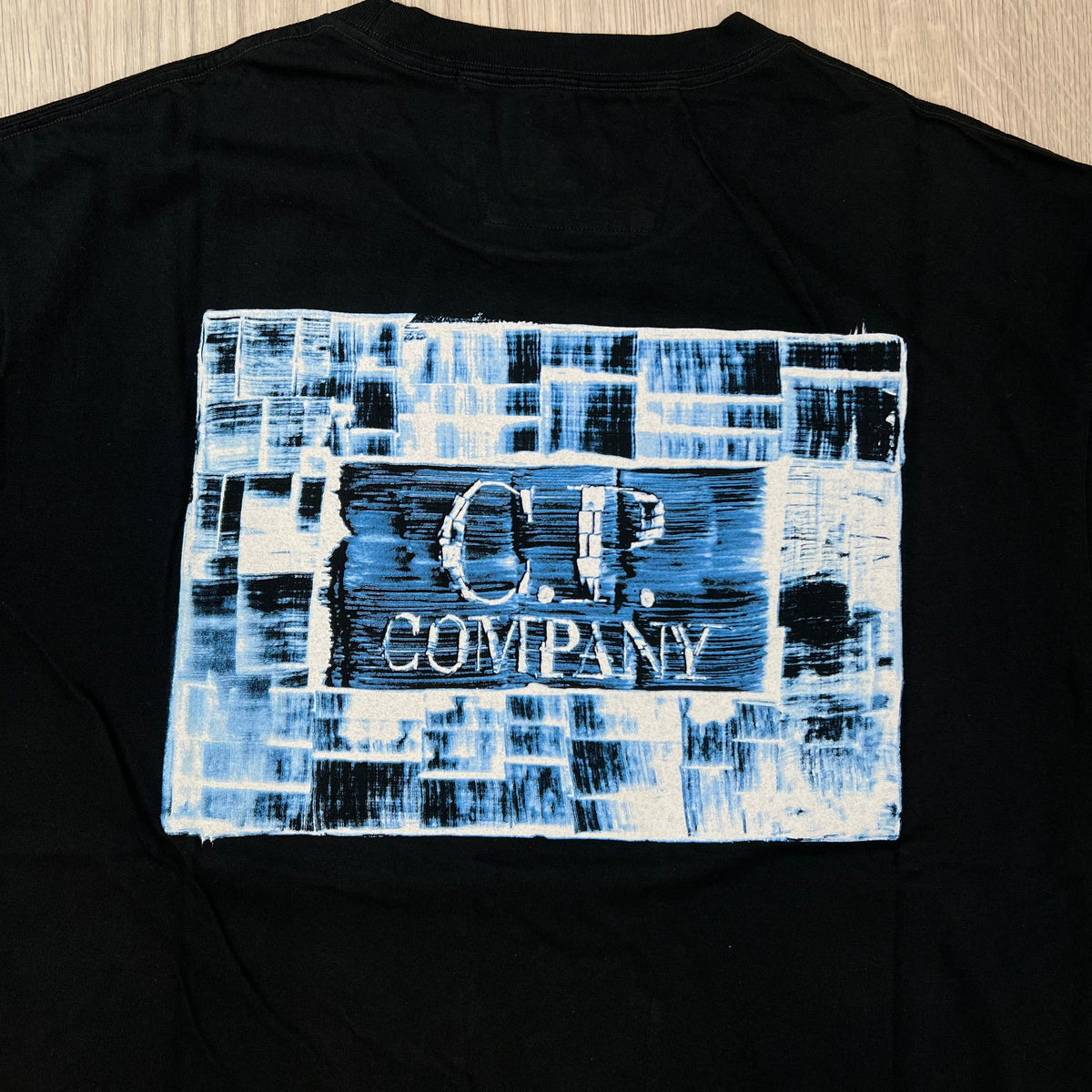 Rear view of the large printed logo on CP Company 30/1 Jersey Graphics T-Shirt in Black.