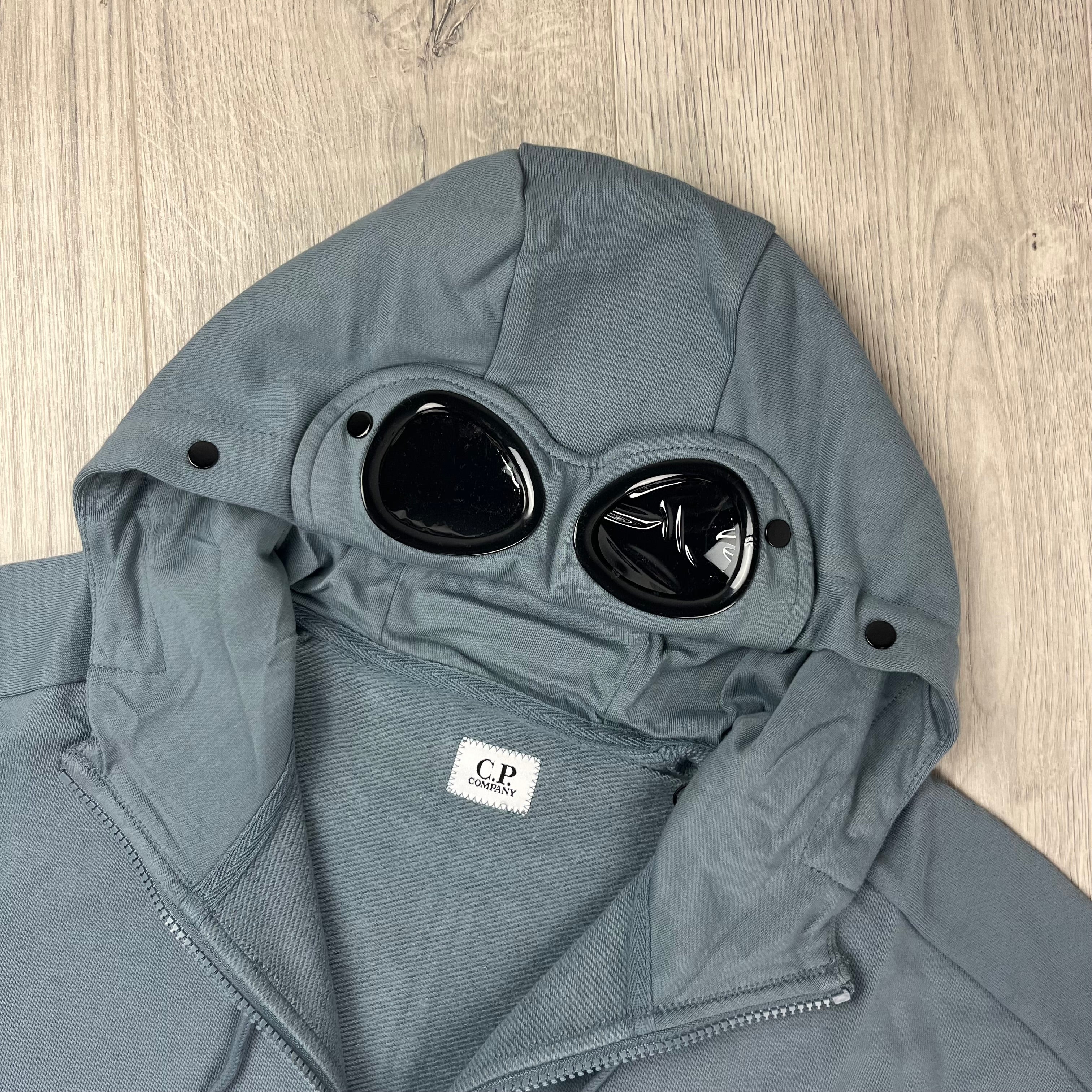 CP Company Diagonal Raised Fleece Goggle Hoodie in Stormy Weather. On sale at Open Attire.