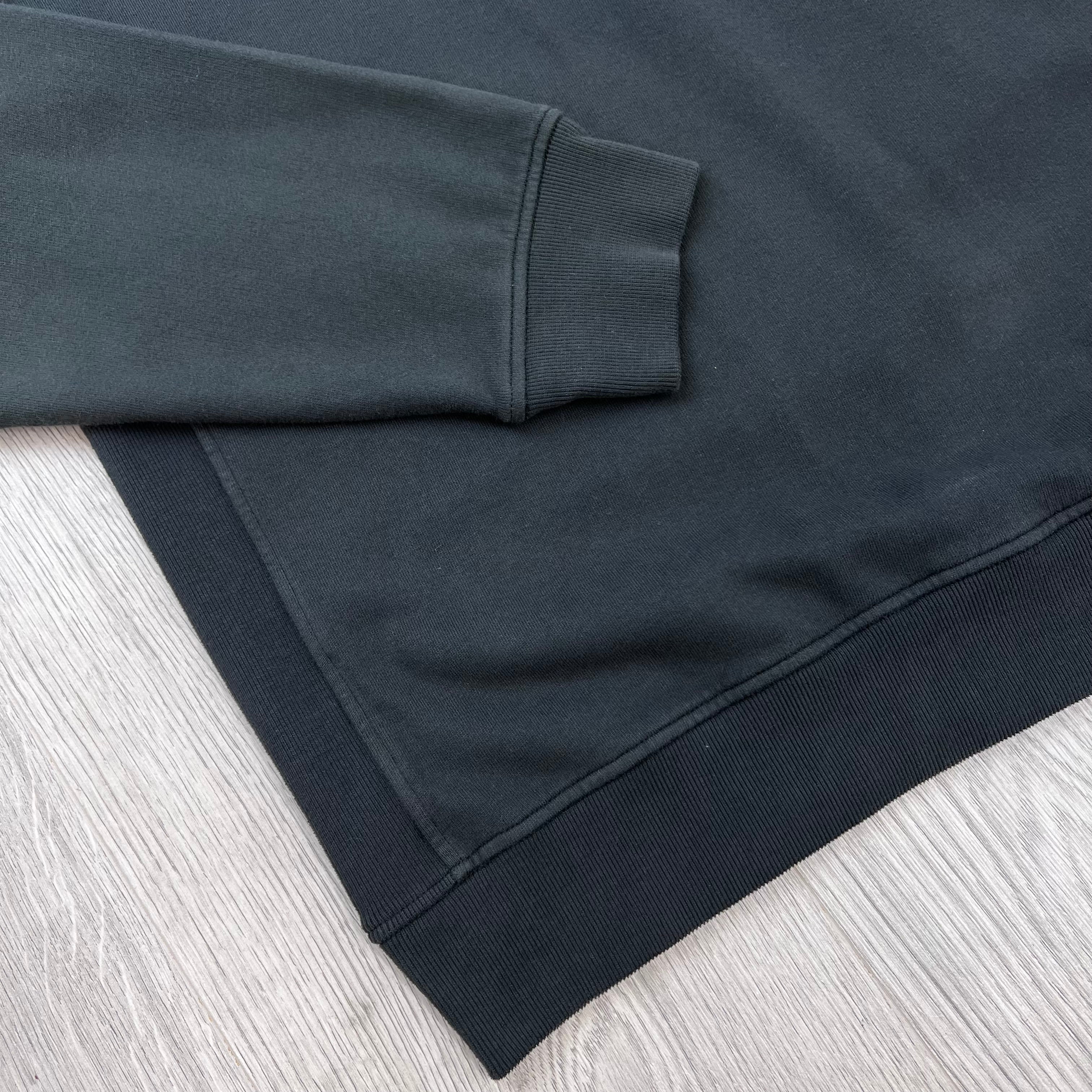 A close up view of the cuffs and hem on a Stone Island Crewneck Brushed Cotton Sweatshirt in Lead Grey.