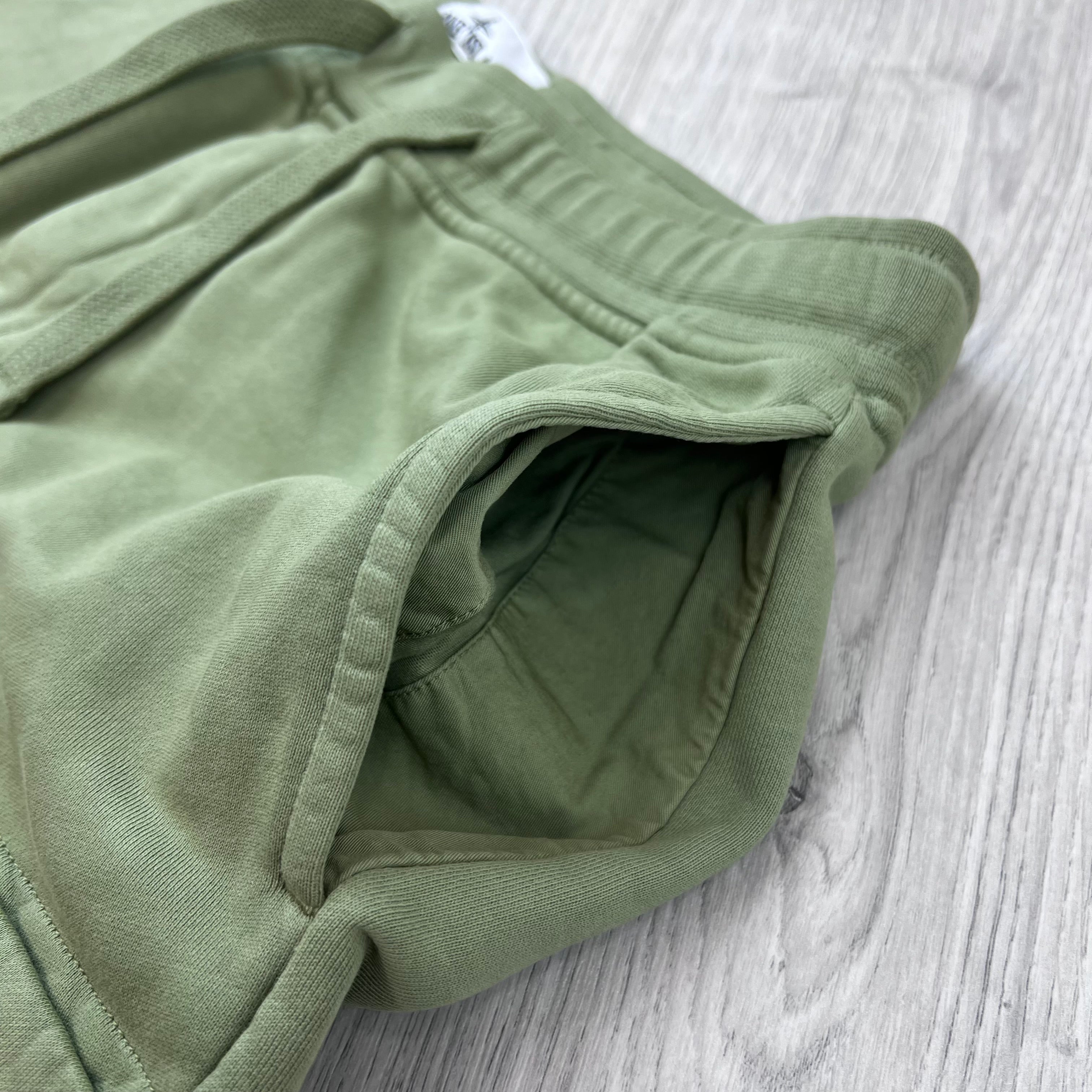 A close up view of the hand pockets on the Stone Island Jersey Shorts in Laurel Green.