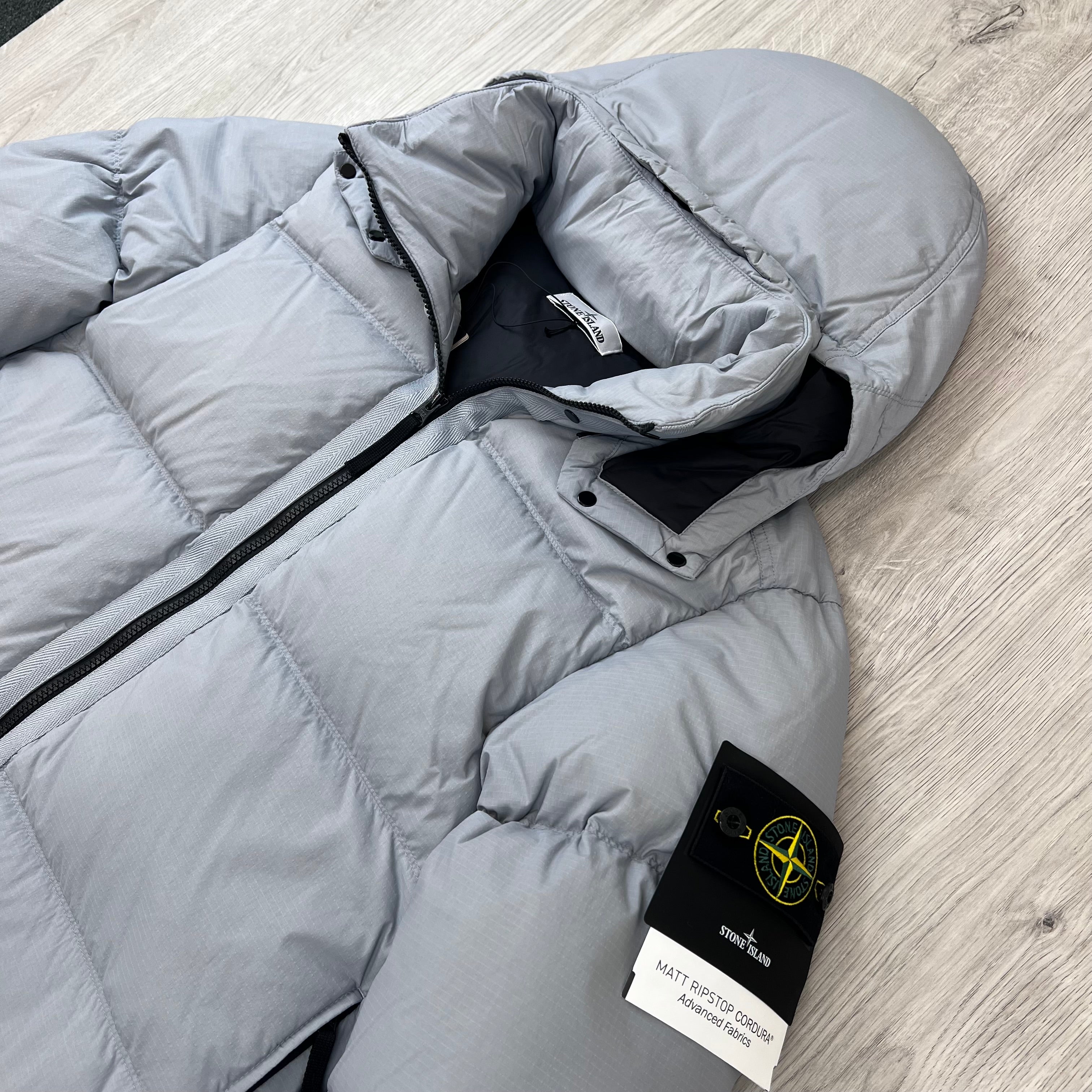 Angled view of the Stone Island Matt Ripstop CORDURA® Down Jacket in Ash Grey.