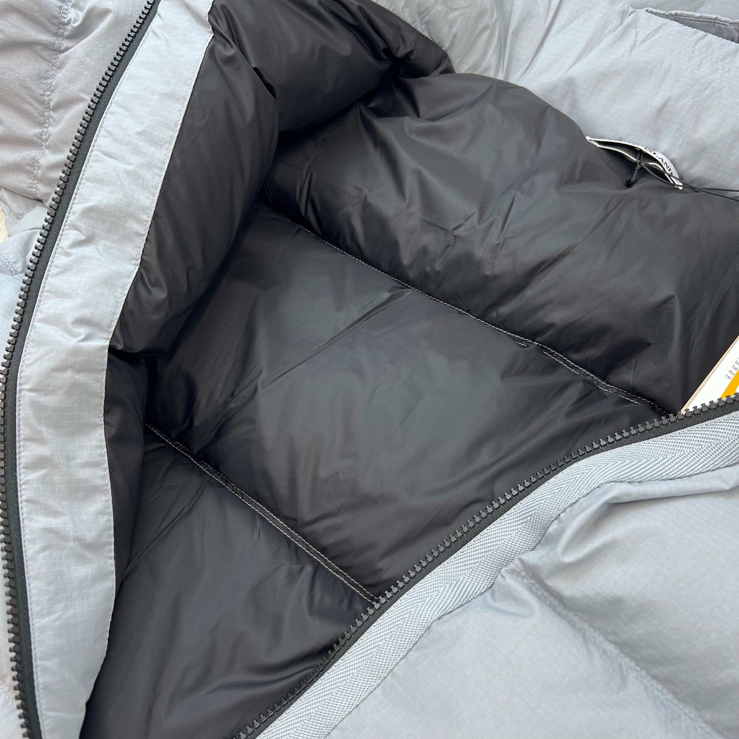 A close up view of the quilting inside a Stone Island Matt Ripstop CORDURA® Down Jacket in Ash Grey.