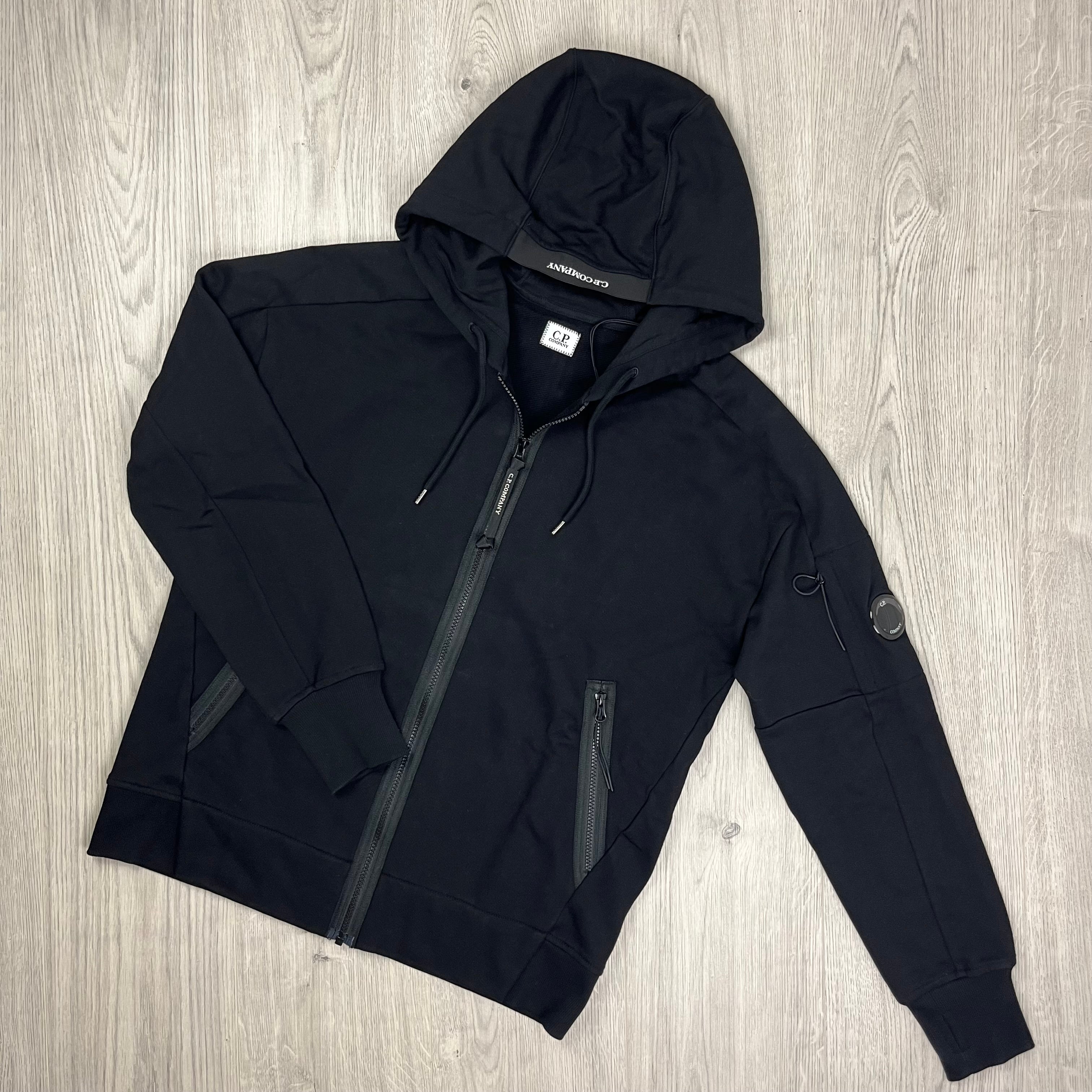 CP Company Diagonal Raised Fleece Zipped Hoodie with sleeve lens detail in Black. On Sale at Open Attire.