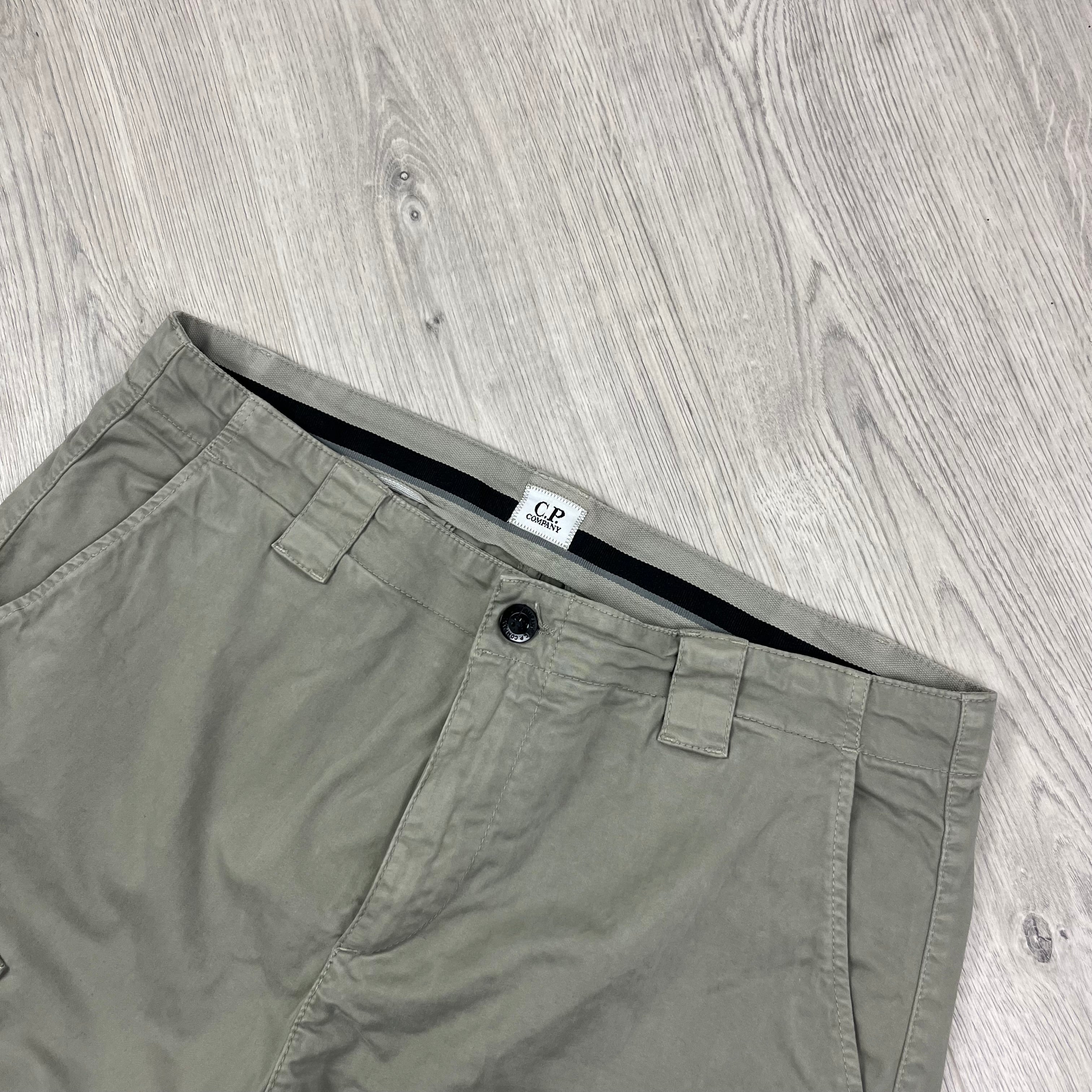 CP Company Stretch Sateen Ergonomic Lens Cargo Pants in Vintage Khaki. On sale at Open Attire.