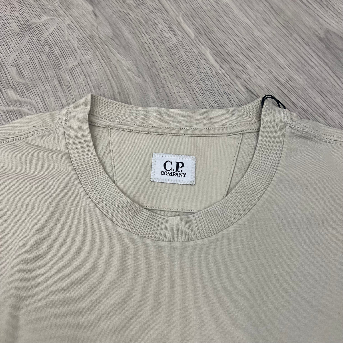 Close up view of the crewneck collar on a CP Company 30/1 Sailor T-Shirt in Silver Birch. 
