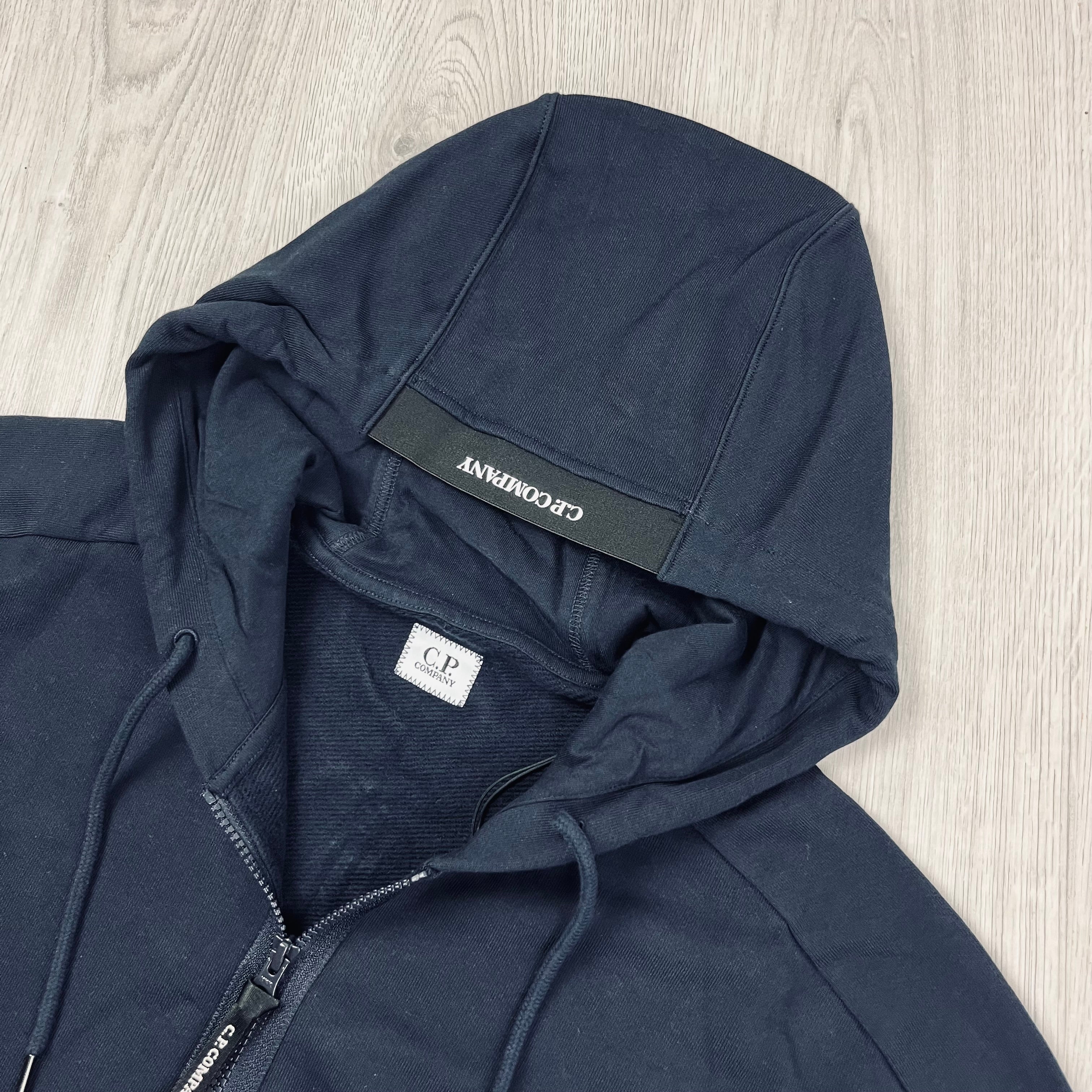 CP Company Diagonal Raised Fleece Zipped Hoodie with sleeve lens detail in Total Eclipse Navy Blue. On Sale at Open Attire.