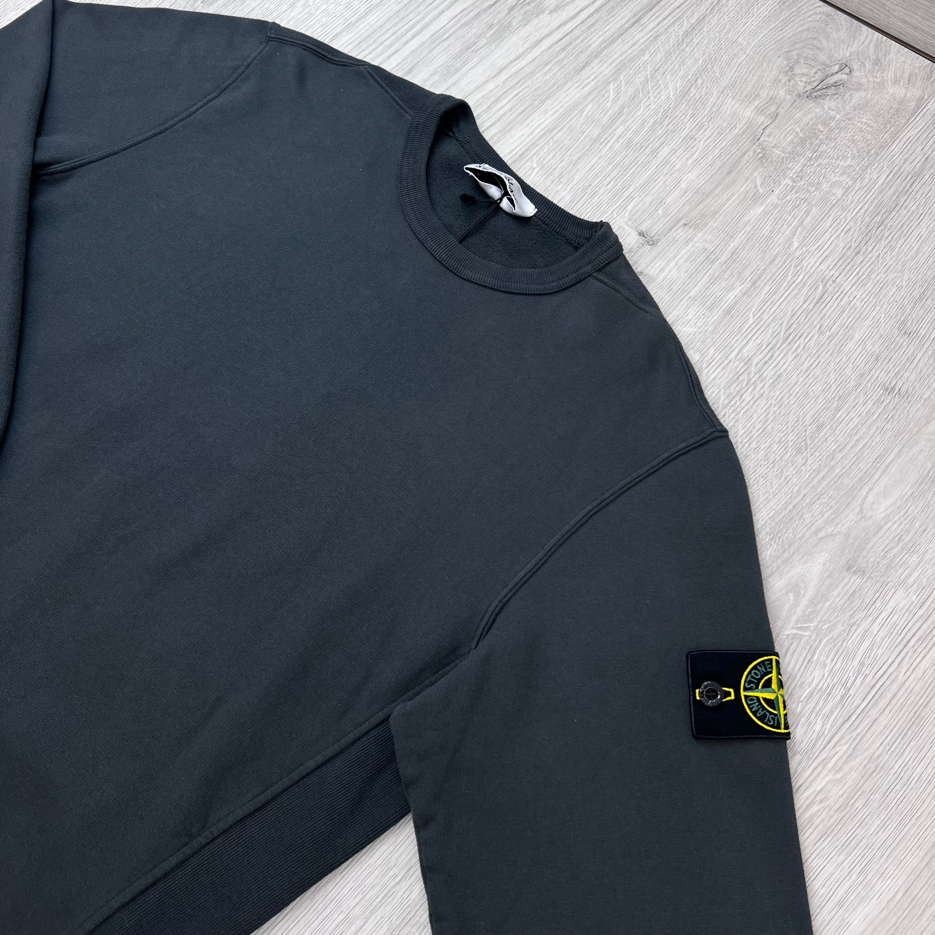 Angled view of the Stone Island Crewneck Brushed Cotton Sweatshirt in Lead Grey.