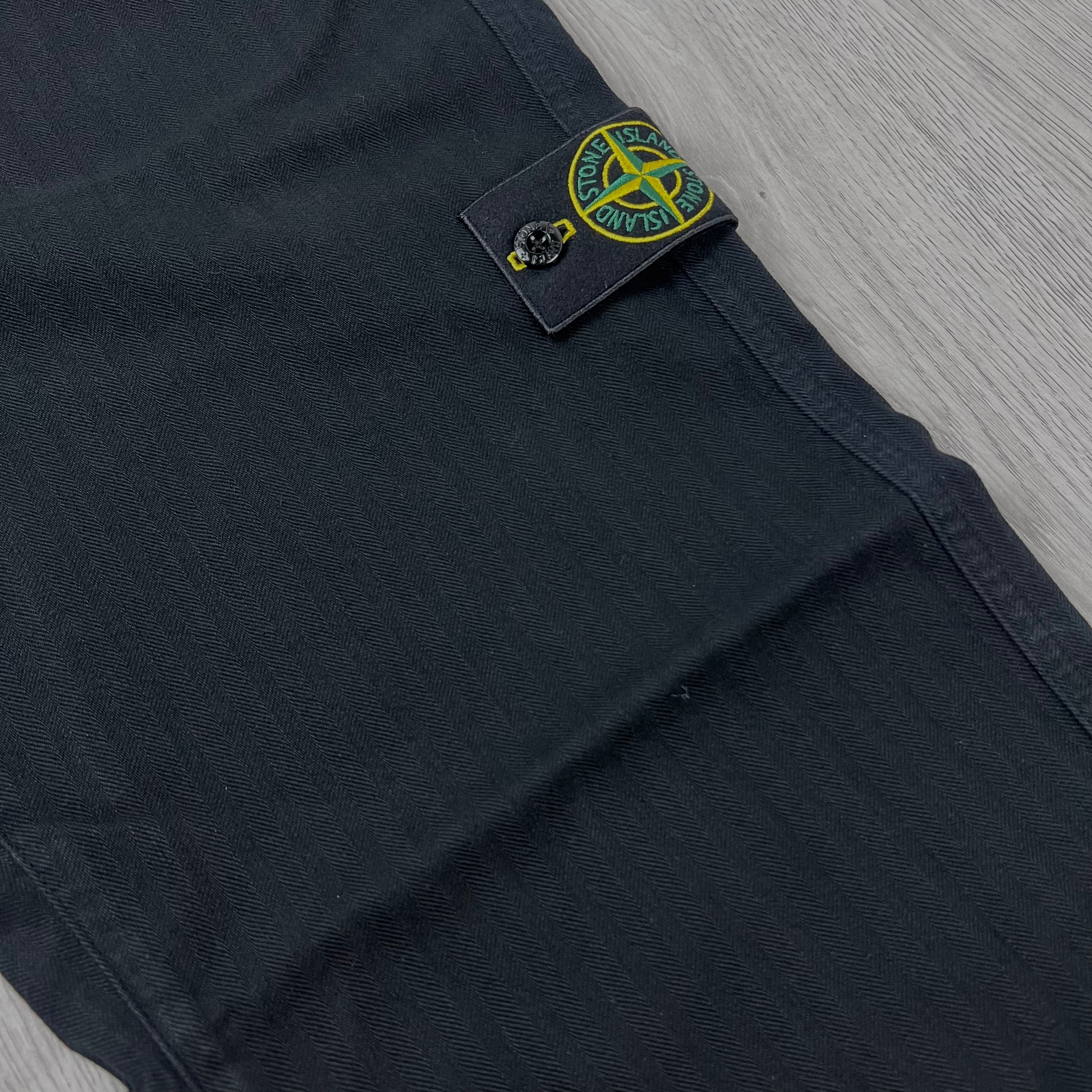 A close up view of the classic pattern on the Stone Island Cotton Herringbone Chino Trousers in Black.