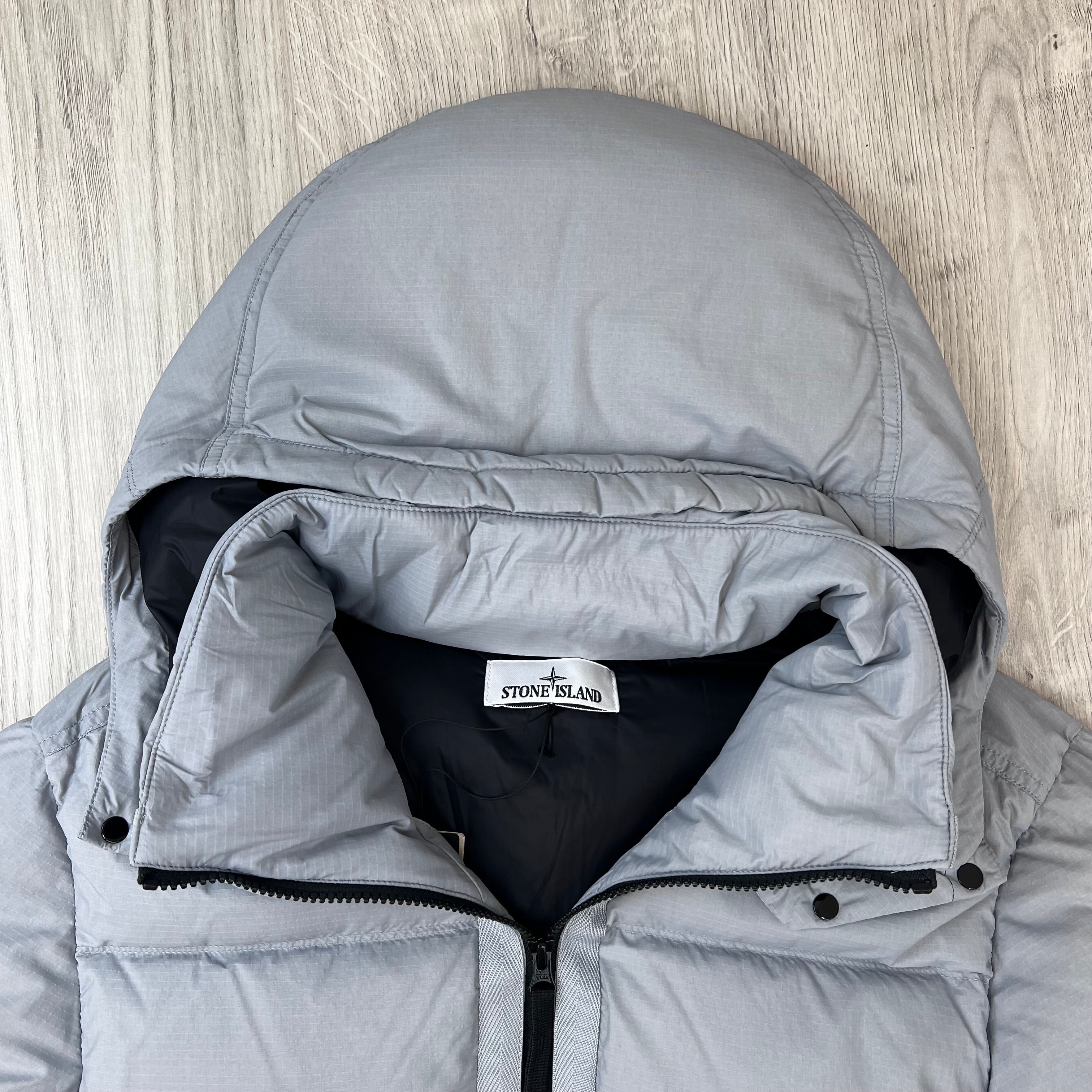 Close up view of the hood on a Stone Island Matt Ripstop CORDURA® Down Jacket in Ash Grey.