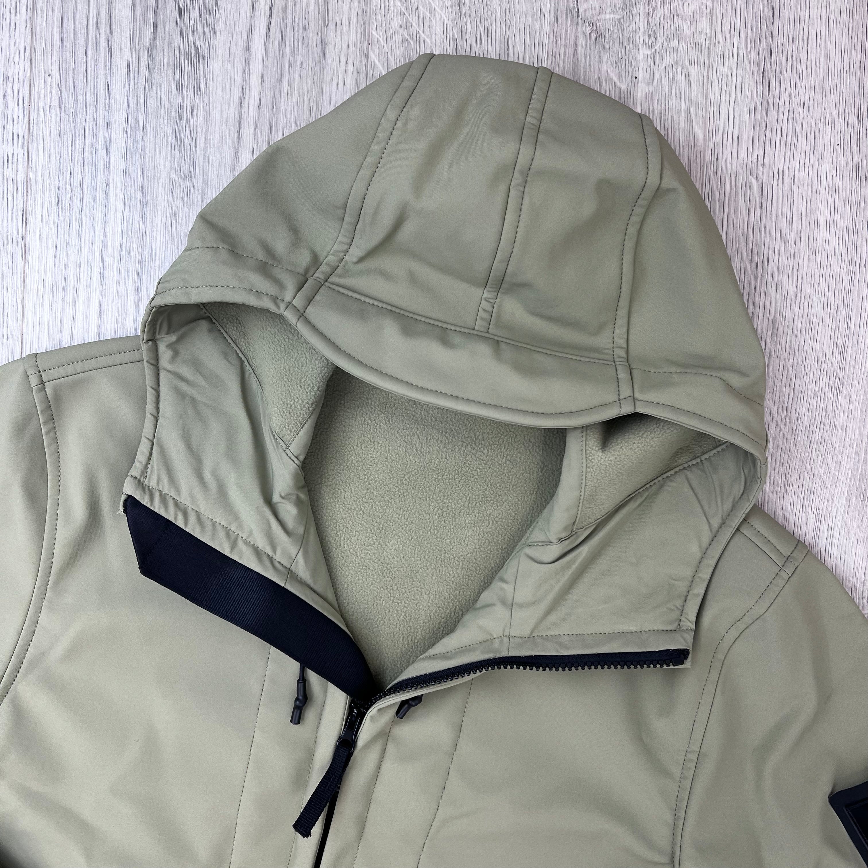 A close up view of the hood on a Stone Island Soft Shell-R_e.dye® Jacket in Laurel Green.